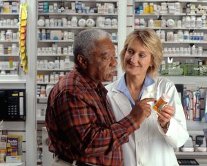 A pharmacist is advising a patient about his medication.